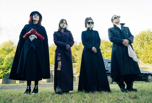 Delia, Astrid and Lydia Deetz are accompanied by Rory at a funeral.